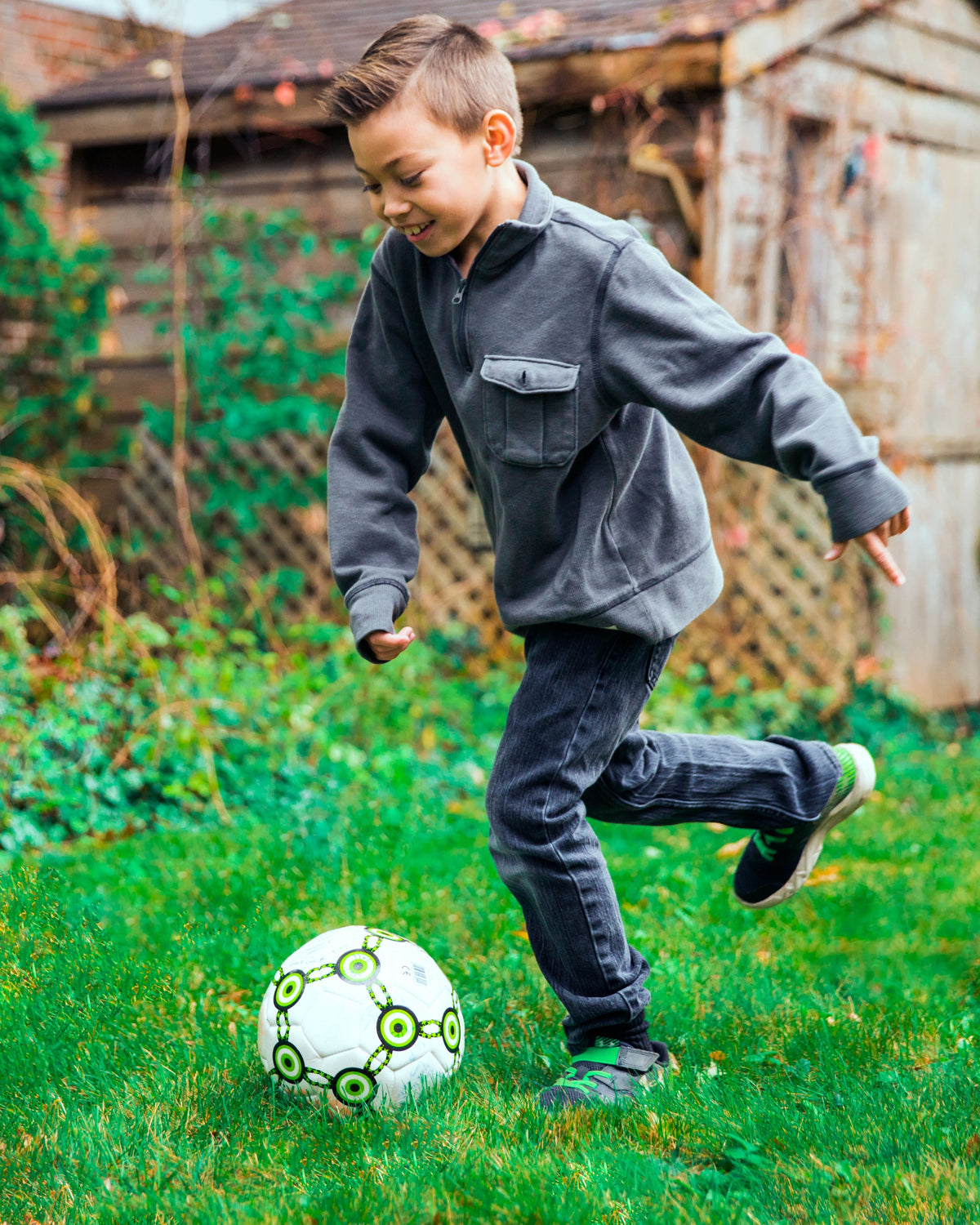 Young boy kicking a ball